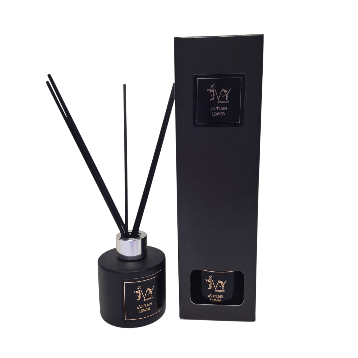 Ivy Blossom Autumn Leaves reed diffuser in a matte black bottle with black reeds next to its matching black box.