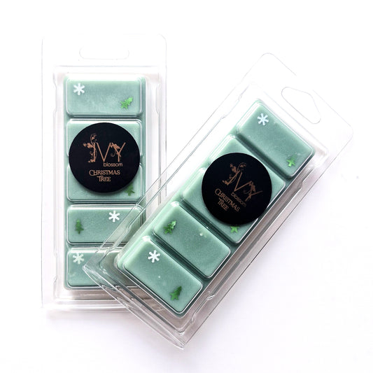 Christmas Tree Wax Melt in green packaging, featuring snowflakes and pine leaf designs, perfect for a festive aroma.