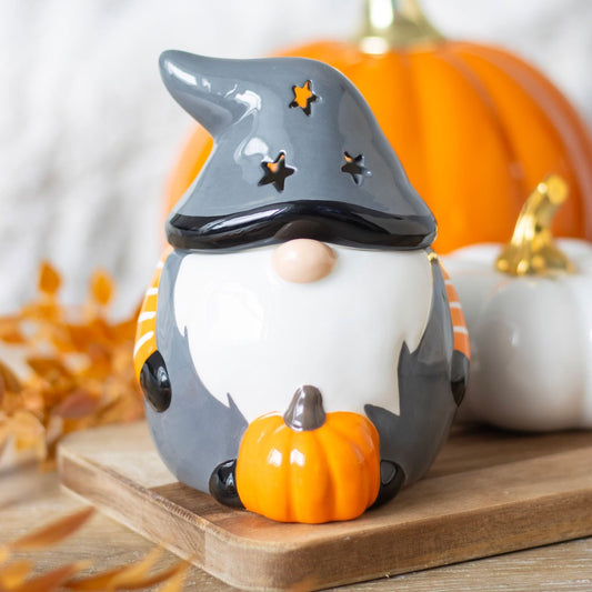 Pumpkin Autumn Gonk Tealight Wax Burner displayed with orange pumpkins and autumn leaves