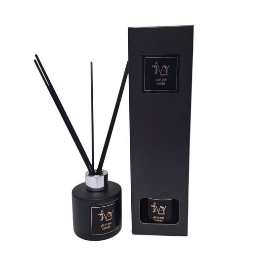 Ivy Blossom Autumn Leaves reed diffuser in a matte black bottle with black reeds next to its matching black box.