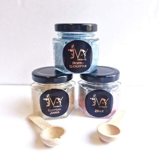 Scented Sizzlers in jars: Frosted Eucalyptus, Egyptian Amber, and Belle with wooden scoops.
